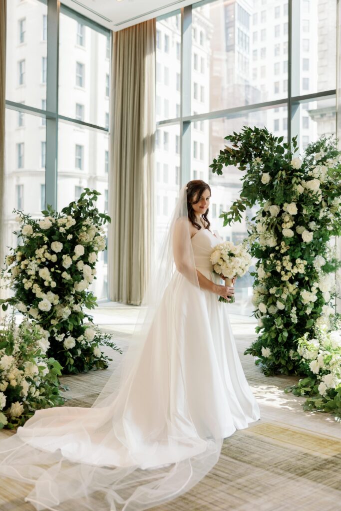 Bride poses in ballroom at Ritz Carlton Nomad in Manhattan, New York.