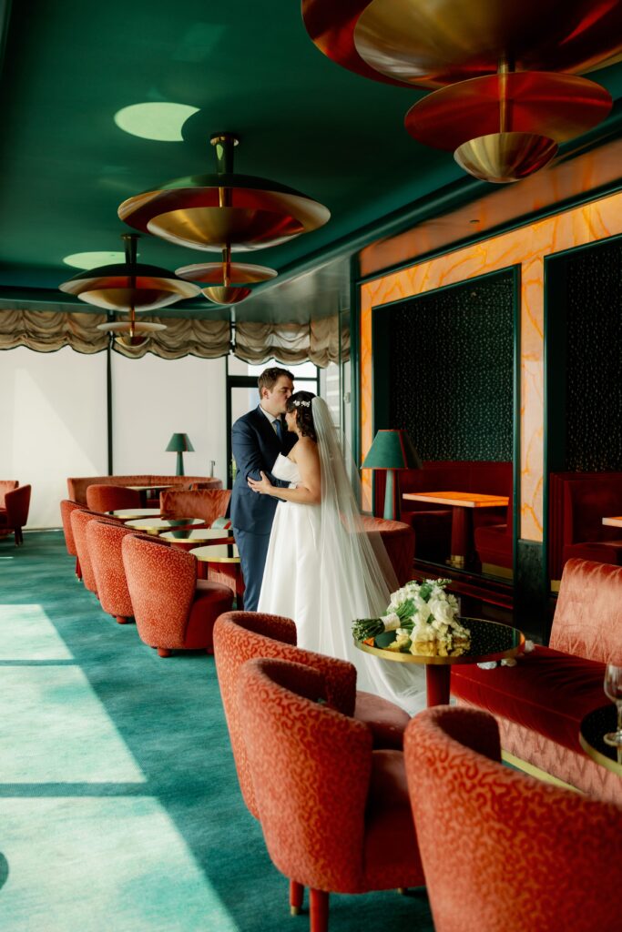 Couple poses on terrace at Ritz Carlton Nomad before wedding.