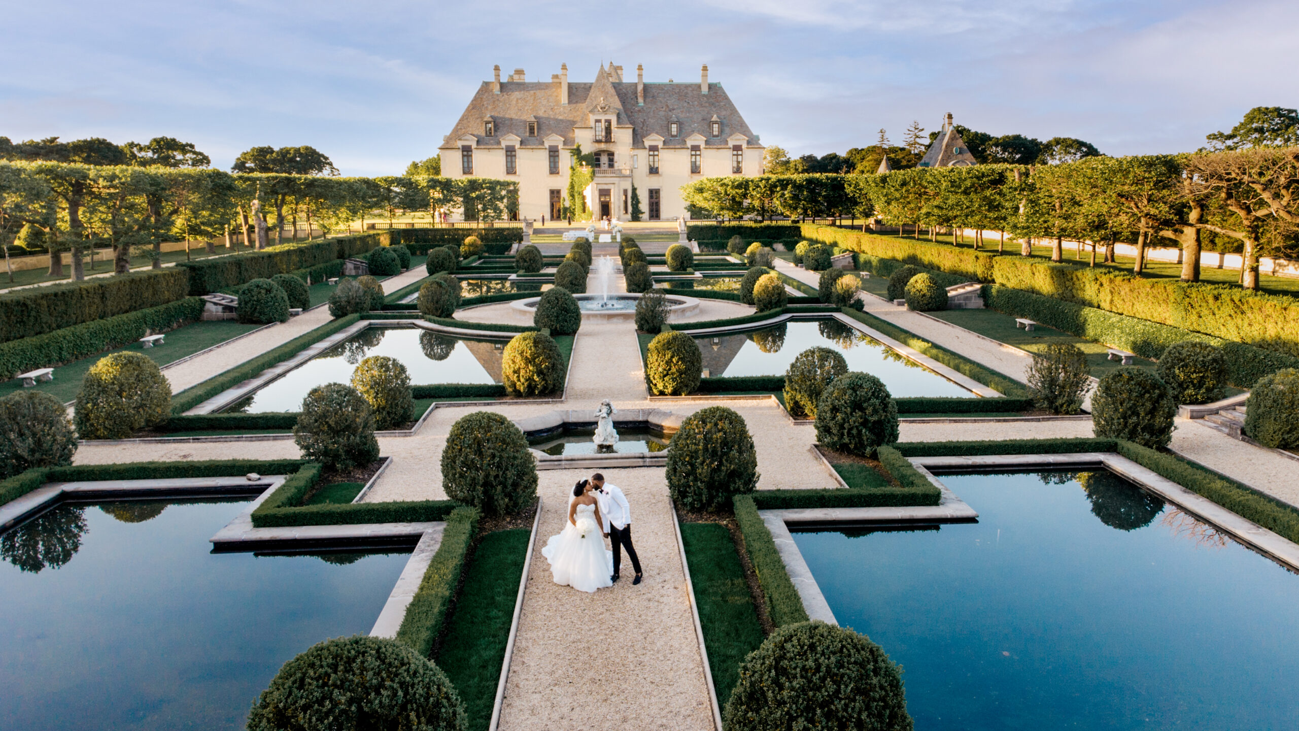 A couple poses outside before wedding at Oheka Castle.